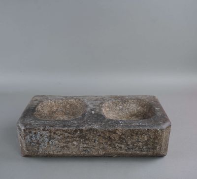 an image of a stone ashtray with two ashtrays in it