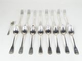 six spoons and six forks are arranged on a white surface