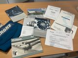 a lot of brochures sitting on a table next to a bag