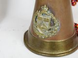 a brass bell with a rope around it on a table