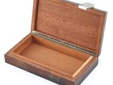 a small wooden box that is open on a white surface