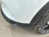 a close up of a car ' s front bumper and tire