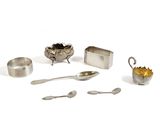 a silver plate with spoons, spoons, and other items on it