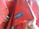 a person holding a red bag with a sticker on it