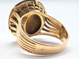 an image of a gold ring with a large stone in the center