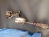 two spoons and a spoon rest on top of a plastic container