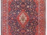 un tapis rouge et bleu à motifs de médaillons