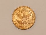 a close up of a gold coin with an eagle on it