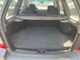 the back of a car with the trunk open and the seats folded down