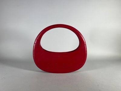 red plastic handbag with handle on white background