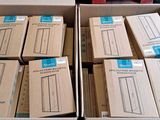 many boxes of electronic equipment sitting on a table