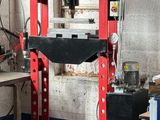 a man working on a machine in a garage