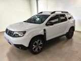 a white dacia is parked in a large room