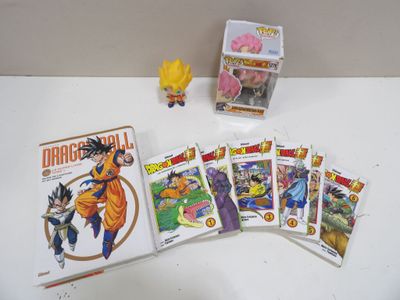 dragon ball trading cards and action figures are on a table
