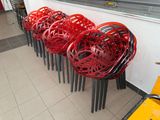 many red chairs lined up in a row on the floor