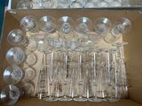 many empty wine glasses in a box on the table
