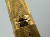 a close up of a gold fountain pen with a ring on it