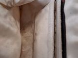 a close up view of a bed with a pillow and a pillow case