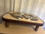 a wooden table with a mosaic design on top of it