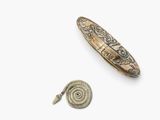 an image of a silver and gold broochle and a silver broochle on a white background