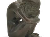 statue of a man sitting on his knees with his head in his hands