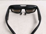 a pair of sunglasses on a bed with a white sheet