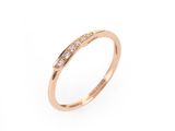 une bague en or rose sertie de diamants sur fond blanc