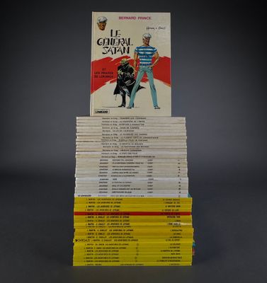 many books stacked on top of each other on a table