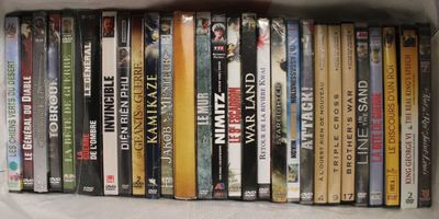 beaucoup de DVD dans une boîte posée sur un lit