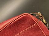 a red piece of luggage that is sitting on a table