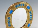 an image of a gold and blue mirror on a white surface