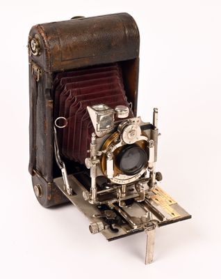 an old camera that is sitting on a white surface