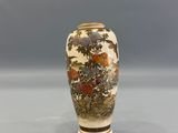 a vase that has flowers on it on a table