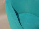 turquoise colored chair with black legs on a white background