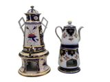 two teapots and a coffee pot sitting next to each other