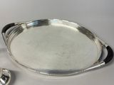 a silver tray with a spoon and spoon rest on it
