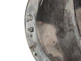 a close up of a metal object on a white surface