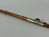 a close up of a wooden and metal instrument on a white surface