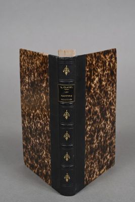 an old book sitting on top of a table covered in a leopard print cover