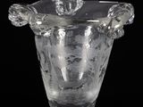 a clear glass vase with a flower decoration on it