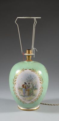 a green vase with a picture of a woman on it
