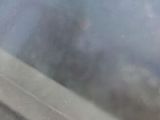a close up view of a window with a reflection of a person