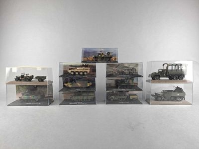 five different models of military vehicles displayed in a display case