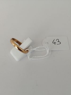 a white and gold ring with a white tag on it