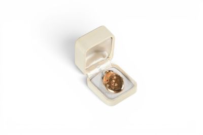 a small white box with a coin inside of it