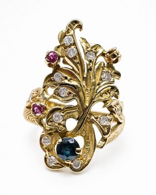 a close up of a gold ring with blue and white stones