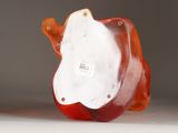 a glass figurine of an apple with a bird on it