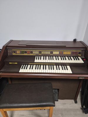 a piano and stool in the corner of the room