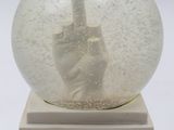 a snow globe with a hand in the middle of it