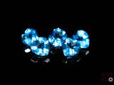 two blue heart shaped crystals are glowing in the dark